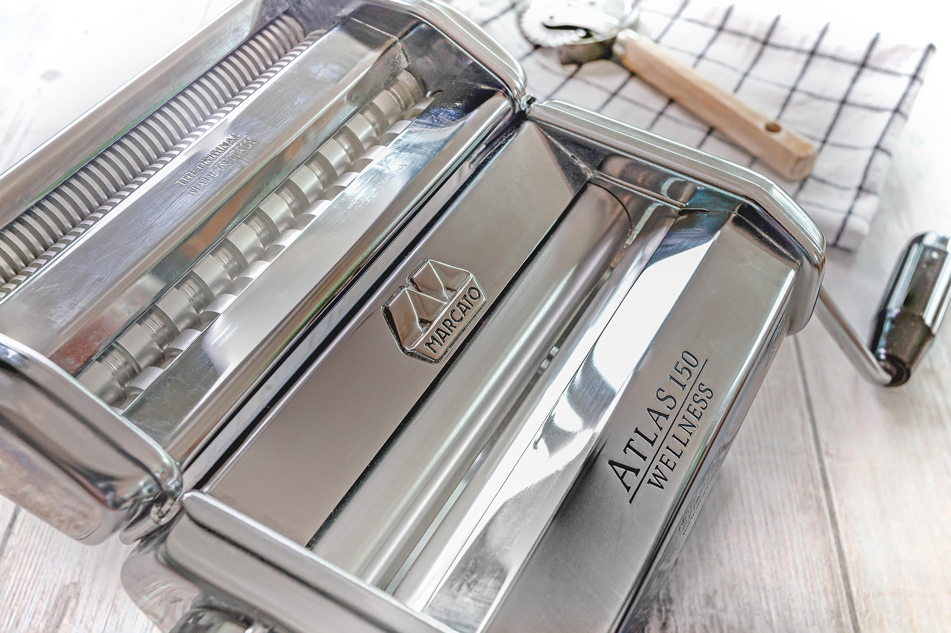 At Home with Angela Gray - pasta machine on wooden table with dough cutter wheel